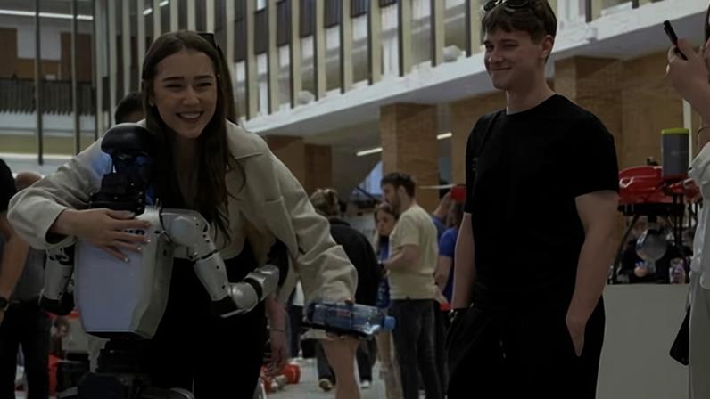 Students in Bucharest interact with an AI-driven humanoid robot.