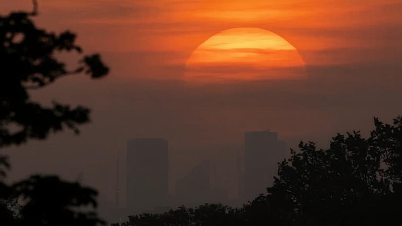 The sun rising over London, seen from Richmond park, on Sunday. The record temperature for May of 32.8C is expected to be broken over the bank holiday weekend.