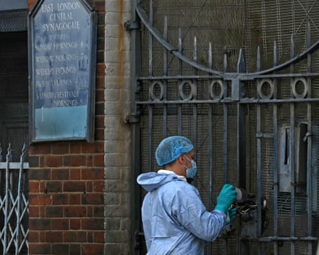 An investigator at the scene of the alleged arson attack in Whitechapel on 5 May.