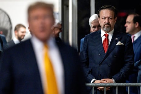 Sebastian Gorka, the White House counterterrorism tsar who spearheaded the new strategy, is pictured behind President Donald Trump.