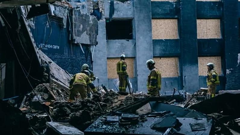 Rescue workers clean up the debris inside the National Chornobyl Museum. The text on the wall reads: ‘Lost worlds’.