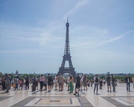 Tourists viewing the Eiffer Tower from the Trocadero Gardens on a hot sweltering day in the French capital as temperatures are predicted to soar to above 30C over the coming days.