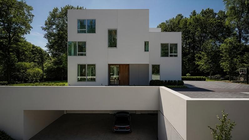 Projetada pelo escritório 1100 Architect, de Nova York, esta residência nos arredores de Boston, Massachusetts, reinterpreta a tradicional arquitetura de tábuas brancas da Nova Inglaterra por meio de uma composição de volumes brancos entrelaçados, revestidos em madeira pintada rente à superfície