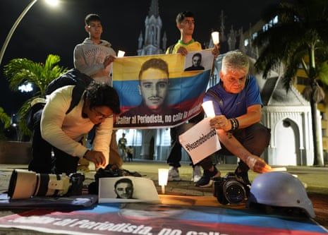 People hold candles and signs during a vigil in Cali this month for the journalist Mateo Pérez Rueda, who was killed by Farc dissidents.