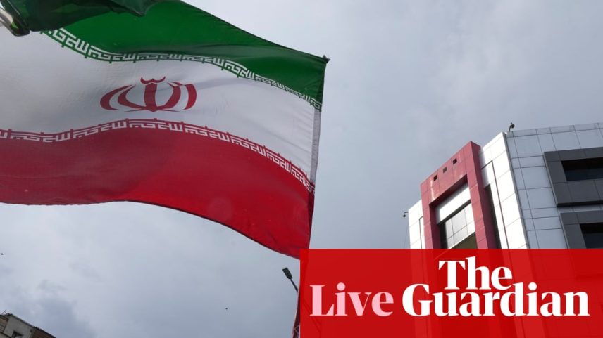 A woman holds an Iranian flag during a pro-government campaign in downtown Tehran on Sunday