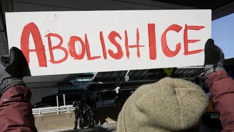 A person holds up an anti-ICE sign during a protest in Minneapolis, Minnesota, on 23 January.