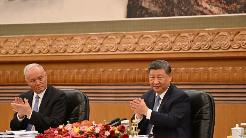Chinese President Xi Jinping, right, and Cai Qi applaud at the Great Hall of the People in Beijing.