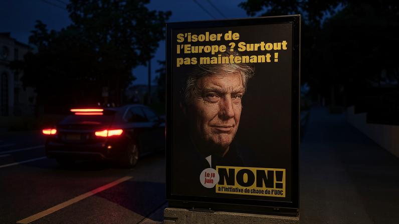 A Swiss political poster depicts US President Donald Trump, with the French slogan "Isolating ourselves from Europe? Certainly not now!" in Lausanne, on May 25.