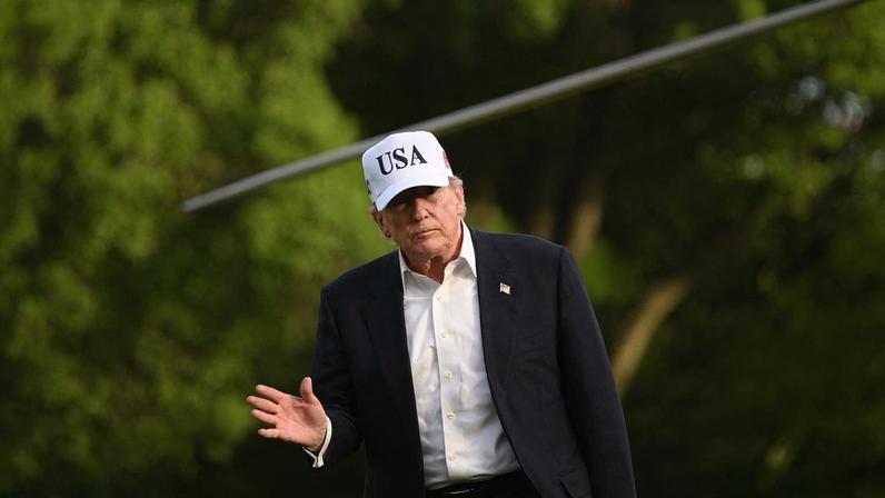 U.S. President Donald Trump waves after stepping off Marine One on the South Lawn of the White House in Washington, D.C.
