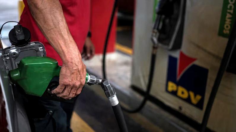 Um funcionário abastece um veículo em um posto da Petróleos de Venezuela, em Caracas, Venezuela.