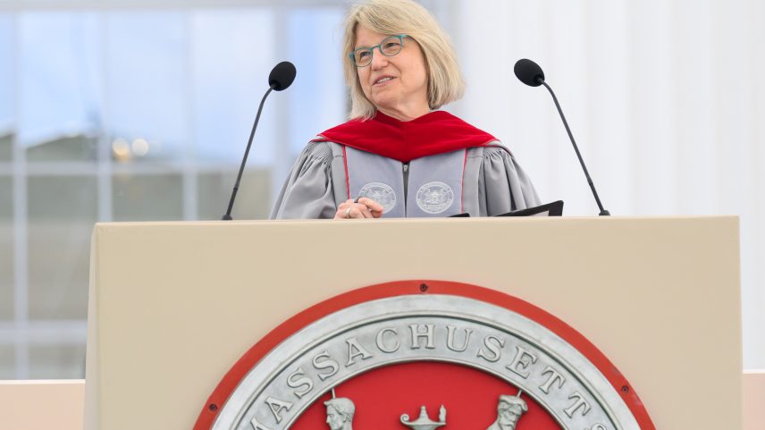 Sally Kornbluth speaks at podium on stage.