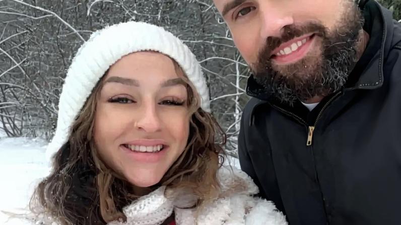 Amanda Conner and Ryan Edwards smiling in a snowy outdoor setting.