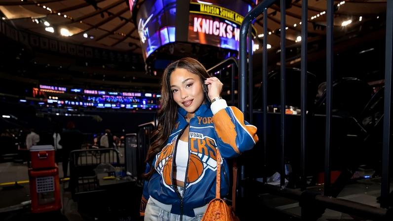 Jordyn Woods has carried the same orange ostrich clutch to every Knicks playoff game this postseason.
