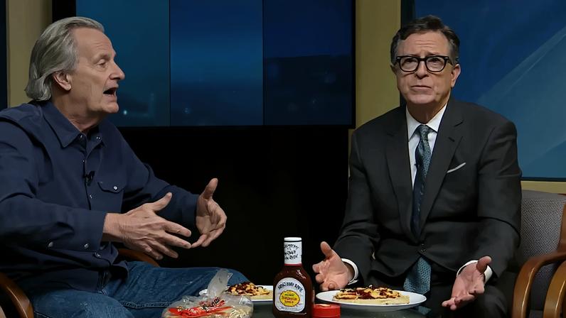 Stephen Colbert shrugs on the set.
