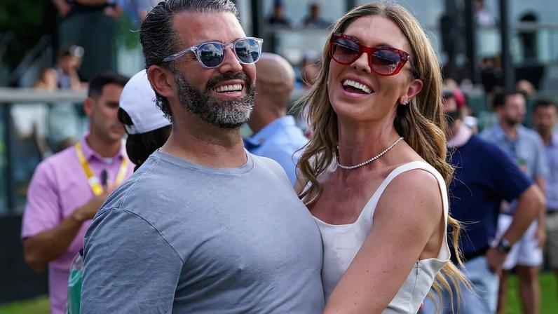 Donald Trump Jr. and Bettina Anderson smiling at the LIV Golf Miami tournament.