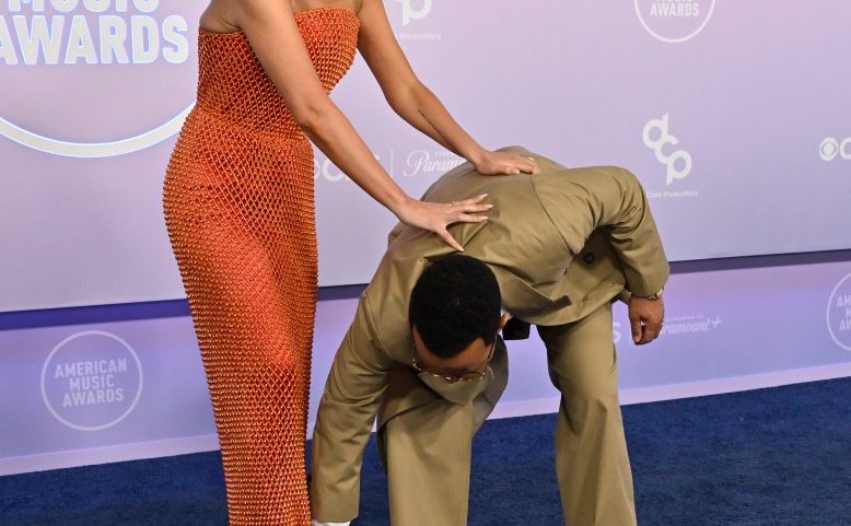 John Legend helped his wife, Chrissy Teigen, after she suffered a wardrobe malfunction at the 2026 American Music Awards Monday in Las Vegas.