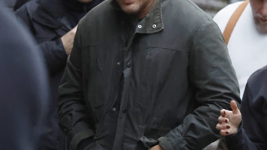 Tom Hardy in a dark green jacket on the set of MobLand.