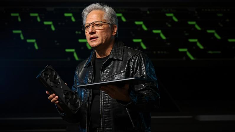 Nvidia CEO Jensen Huang with an RTX laptop at CES 2025.