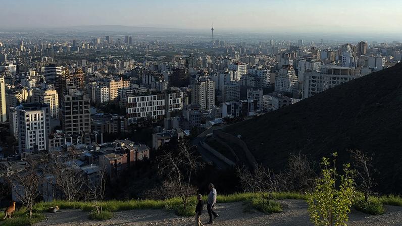 People walk at Pardisan Park overlooking the city in Tehran.