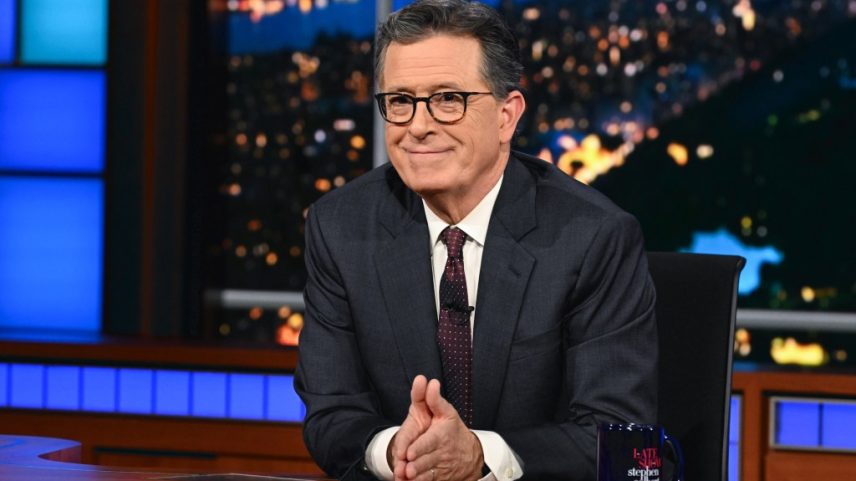 Stephen Colbert at the desk of The Late Show.