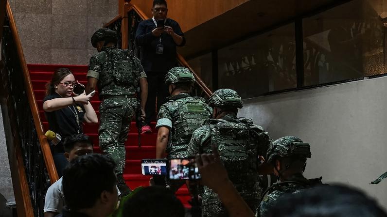 Troops arrive after the exchange of gunshots inside the Senate of the Philippines in Manila on May 13.