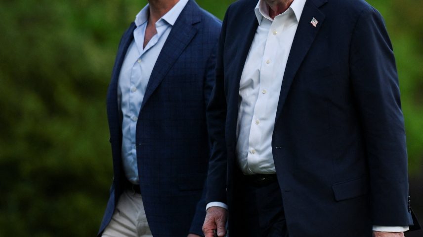 Donald Trump, pictured above with Don Jr. earlier this month, explained via Truth Social why he won’t be attending his son’s nuptials to Bettina Anderson.