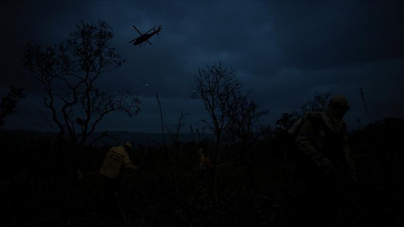 Firefighters from the Chico Mendes Institute work to contain a forest fire and prevent it from reaching Chapada dos Veadeiros National Park, in Brazil’s northern Goiás state in 2025.