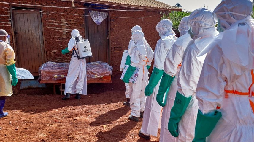 Red Cross workers wearing personal protective equipment (PPE) disinfect the house of an unidentified man who died of Ebola before retrieving his body, as aid agencies intensify efforts to contain a new Ebola outbreak involving the Bundibugyo strain, in Quartier Shuni 1, a residential sector in Mongbwalu, Djugu Territory of Ituri province, Democratic Republic of Congo, May 24, 2026. REUTERS/Gradel Muyisa Mumbere