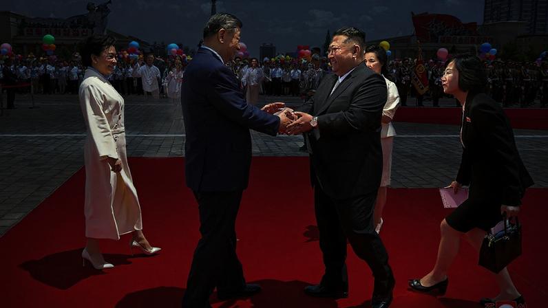 North Korean leader Kim Jong Un (centre R) shaking hands with China's President Xi Jinping (centre L) during a welcoming ceremony at Kim Il-sung Square in Pyongyang, June 8, 2026.