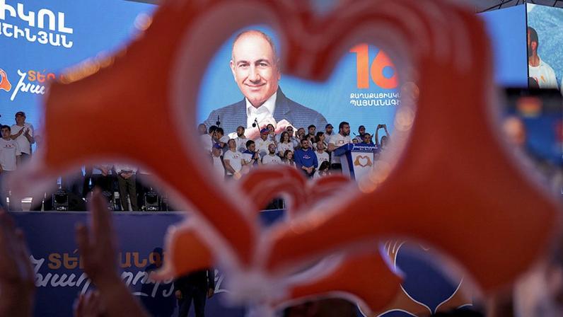 Supporters of Armenia's ruling Civil Contract party leading by Prime Minister Nikol Pashinyan hold up heart signs while gathering in Republic Square in Yerevan