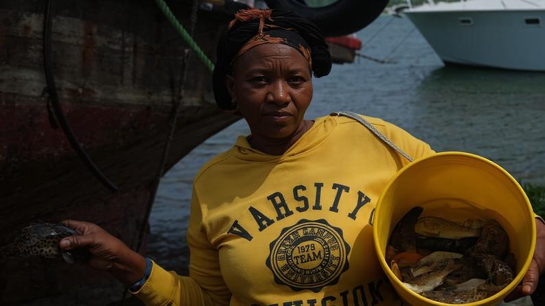 Alice Kazungu, a fishmonger and vice chair of the newly formed Mida Beach Management Unit (BMU), in Watamu, Kenya. Image by David Akana/Mongabay.