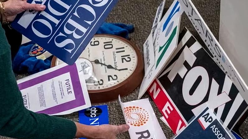 The Washington Post reporter Tara Copp saves the name plaques from various news organizations as she and members of the media pack up their belongings in the press area in the Pentagon.