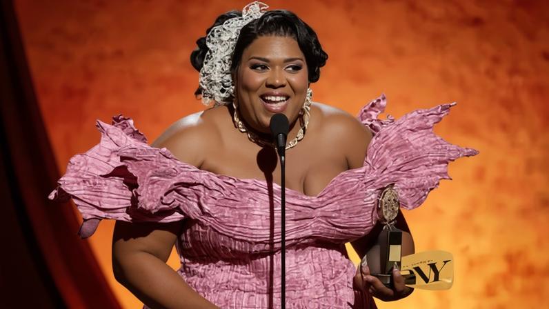 Qween Jean accepts the best costume design of a musical award for Cats: The Jellicle Ball.