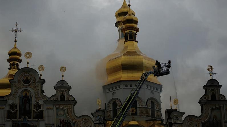 Firefighters extinguish a fire on the roof of the Dormition Cathedral of the Kyiv Pechersk Lavra hit by a Russian drone strike