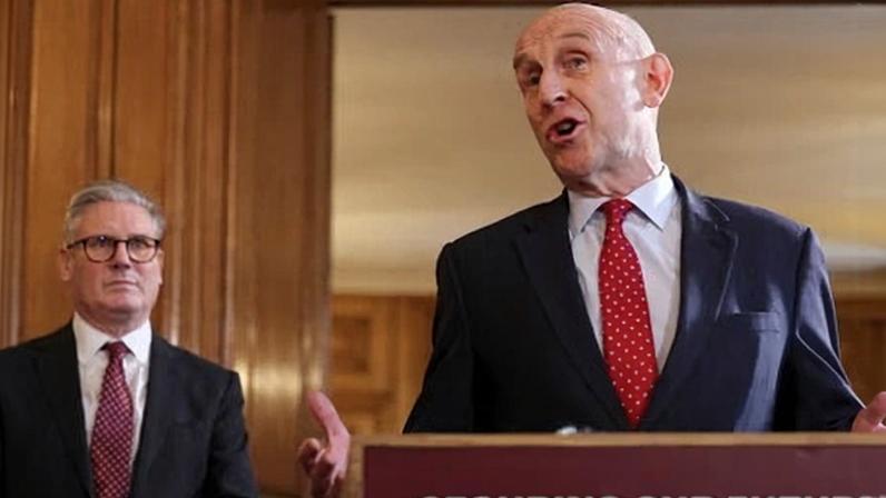 Keir Starmer looks on as defence secretary John Healey makes a speech. Healey resigned on Thursday.