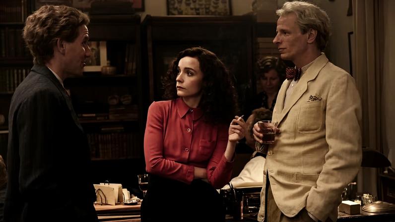 Still from *Leonora in the Morning Light* with Leonora Carrington (Olivia Vinall) with André Breton (Denis Eyriey) and Max Ernst (Alexander Scheer) © Luna Zscharnt, Dragonfly Films, Alamode Films