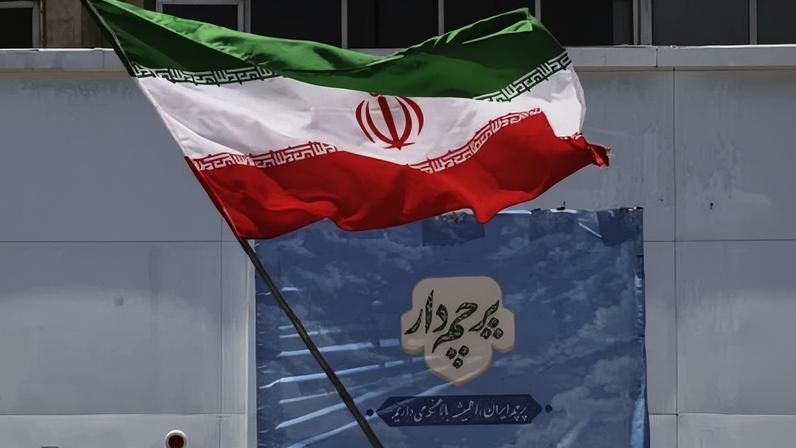 An Iranian woman waves a national flag at Valiasr Square in Tehran.