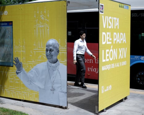 A man walks past an advertisement for Pope Leo XIV's trip to Madrid, part of a six-day tour, including stops in Barcelona and the Canary Islands.