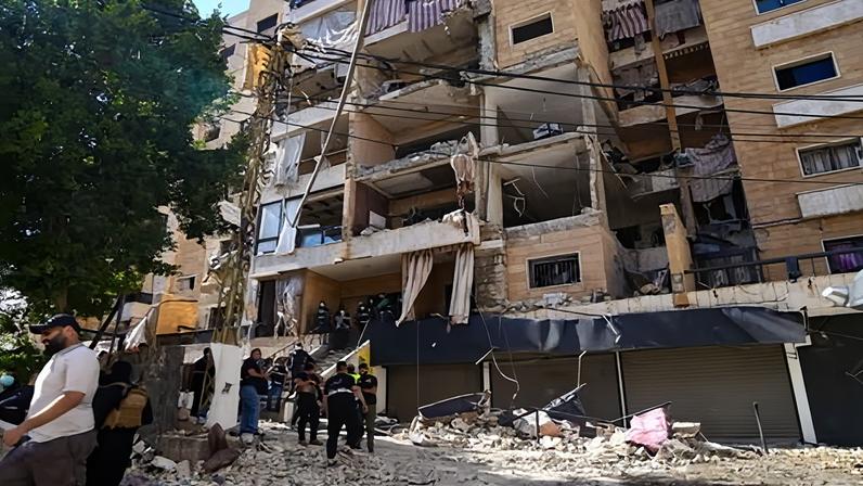Rescuers work at the site of an Israeli airstrike that hit a building in the southern suburbs of Beirut on Sunday. That strike triggered retaliatory missile launches from Iran.