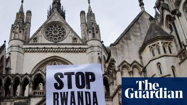 People holding up signs reading: 'Stop Rwanda' and 'All refugees welcome' in front of the building.