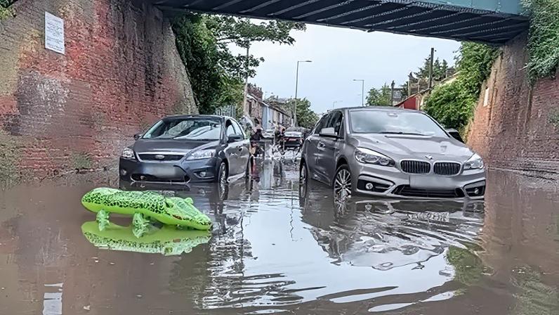 Motorists - and even an inflatable alligator - found themselves stuck in flood water in Ipswich
