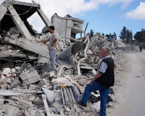 People check over a destroyed home in Beer al-Salassel, south Lebanon as they return on Monday after the latest ceasefire.