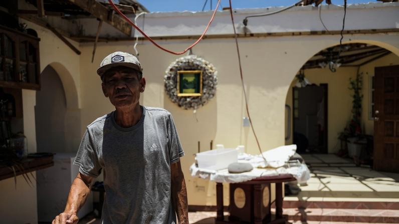 Harsh sun floods the homes of local families. Their belongings are either stored away or ruined by the storm. Family artifacts and heirlooms now litter living spaces as jagged wood hangs from rafters.