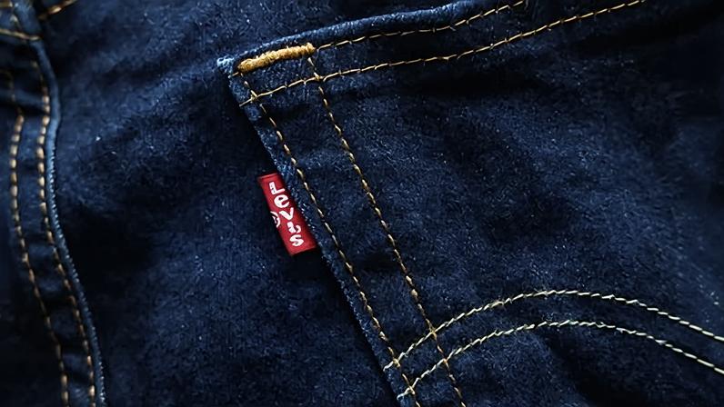 a pair of blue Levi's jeans featuring a red tab on the pocket