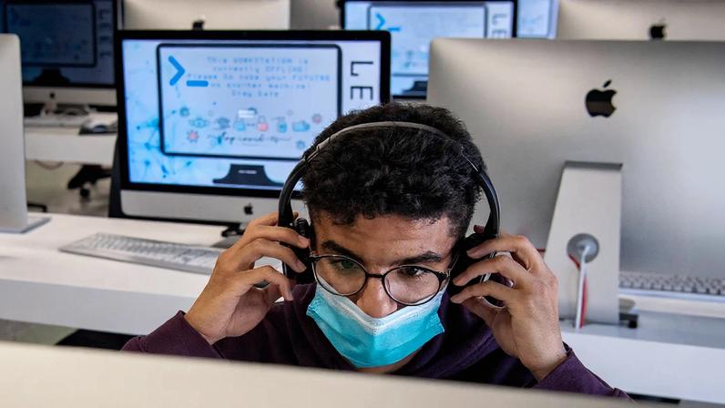 A student adjusts his headset as he uses a computer at a lab room in Morocco's central city of Khouribga on Nov. 17, 2020.