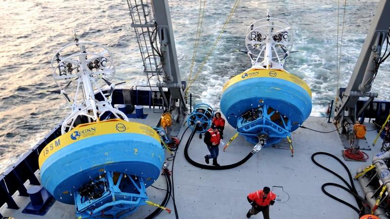In this 2021 image provided by Woods Hole Oceanographic Institution, workers walk near buoys used to gather data at Pioneer New England shelf off the coast of Martha’s Vineyard, Mass. Image courtesy of Véronique LaCapra/Woods Hole Oceanographic Institution via Associated Press.