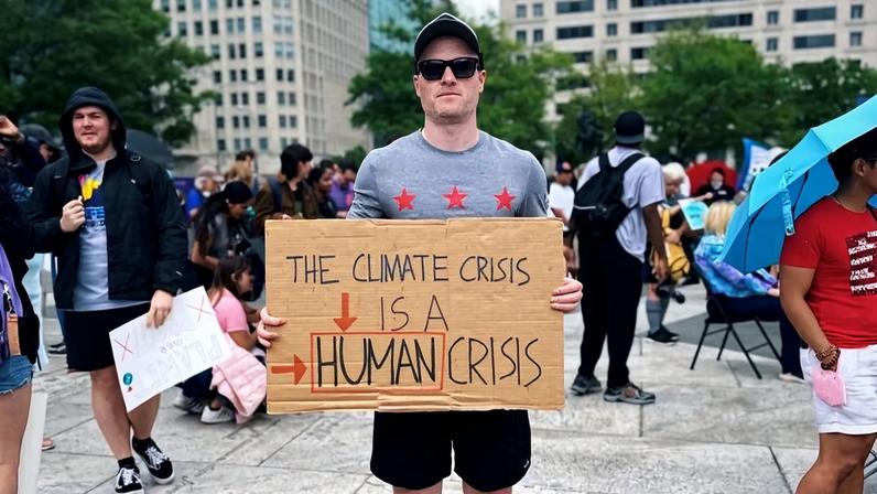 Will Hackman at an Earth Day event in Washington, D.C. He argues that effective climate messaging should be framed around protecting people and communities, rather than saving the planet. Photo courtesy of Will Hackman.
