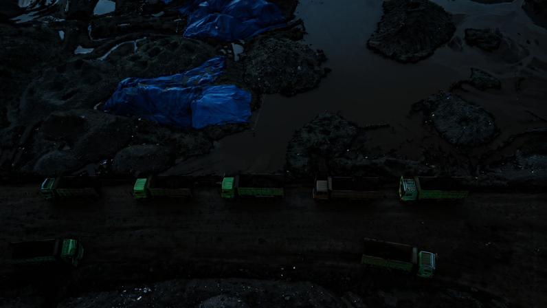 An aerial view shows dump trucks loaded with nickel ore at a mining site in North Konawe, Southeast Sulawesi, Indonesia, on Aug. 3, 2023.