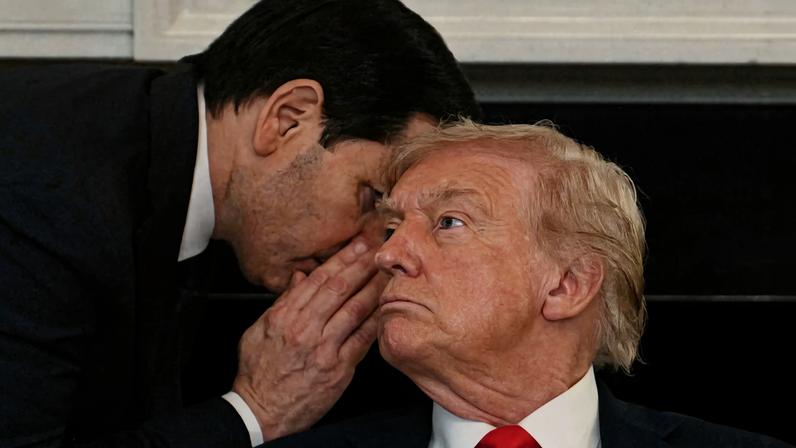 US Secretary of State Marco Rubio whispers in the ear of President Donald Trump during a roundtable about Antifa in the State Dining Room of the White House in Washington, DC, on October 8, 2025.