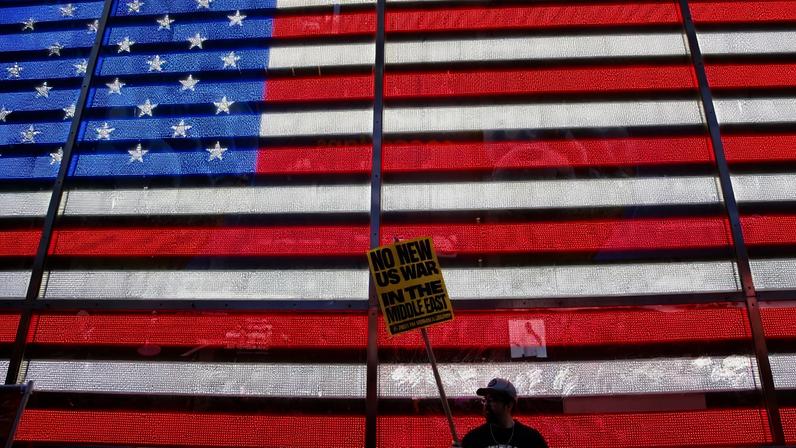 A person holds a sign during a Stop the War on Iran protest at Times Square in New York City on Feb. 28.